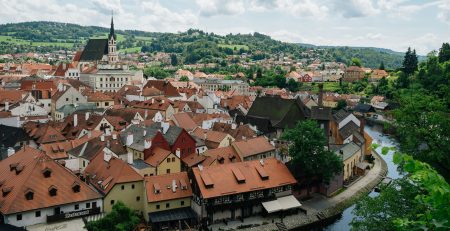 photo of Český Krumlov, Czech Republic water way and buildings with orange roofs
