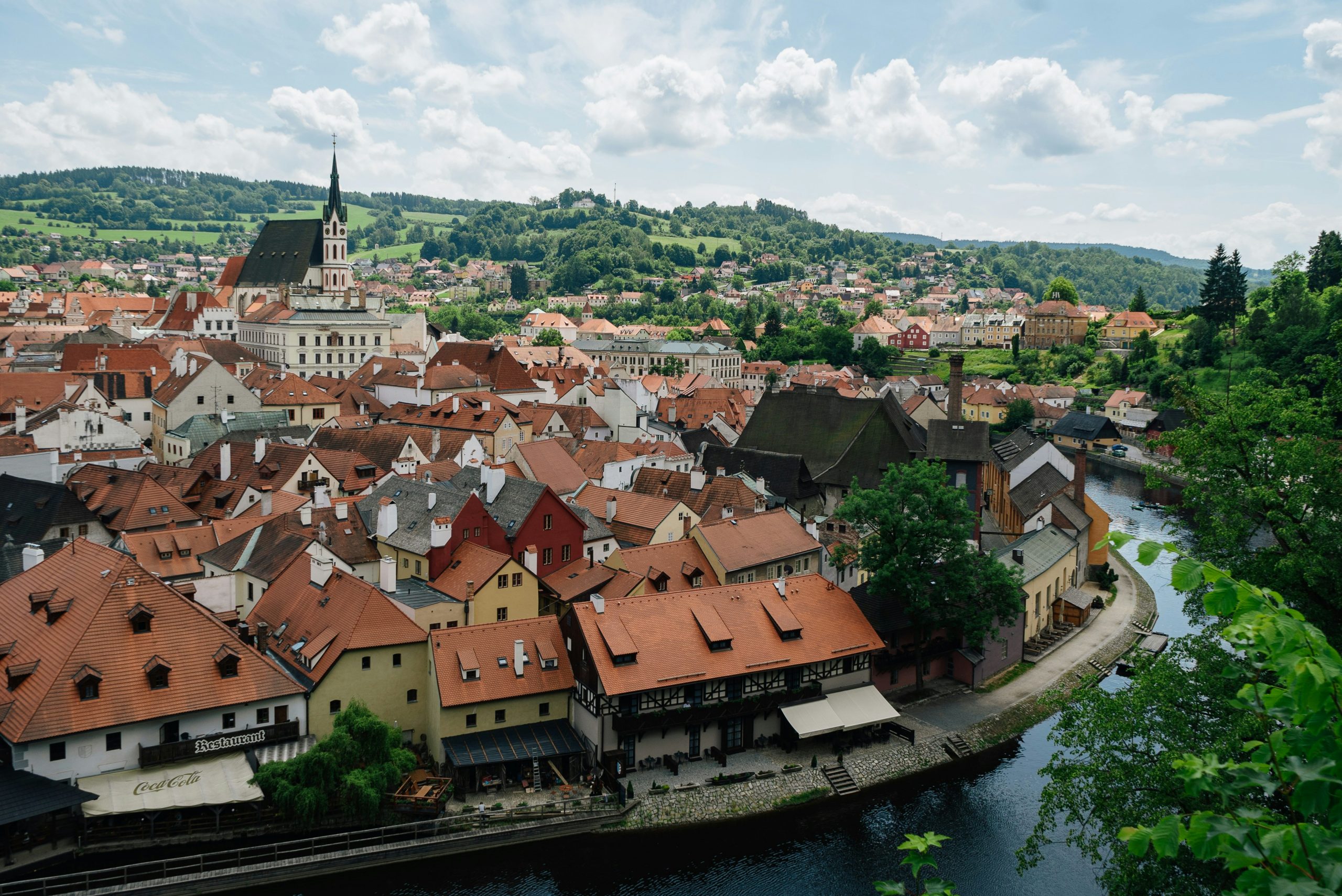 photo of Český Krumlov, Czech Republic water way and buildings with orange roofs
