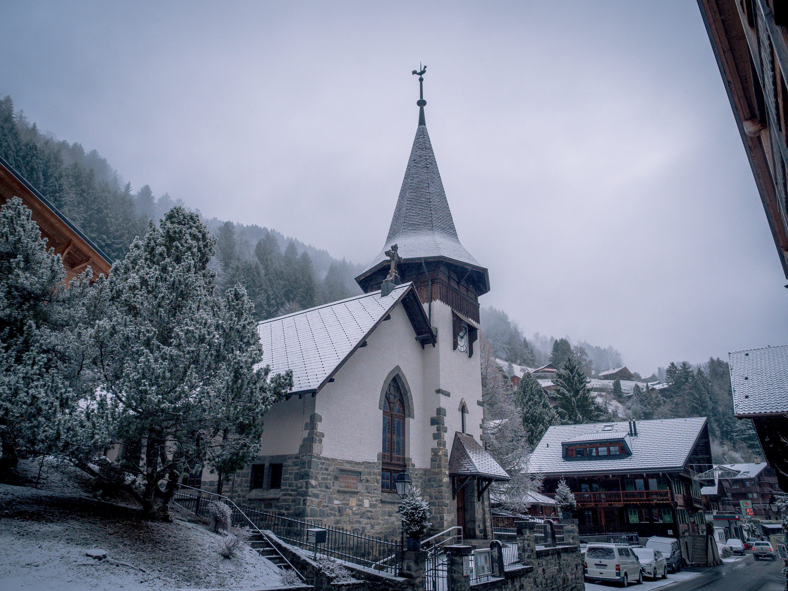 A quaint church in a snowy mountain village.