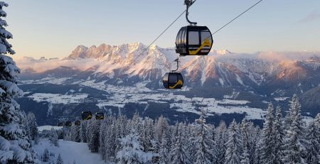 black cable car over snow covered mountain during daytime
